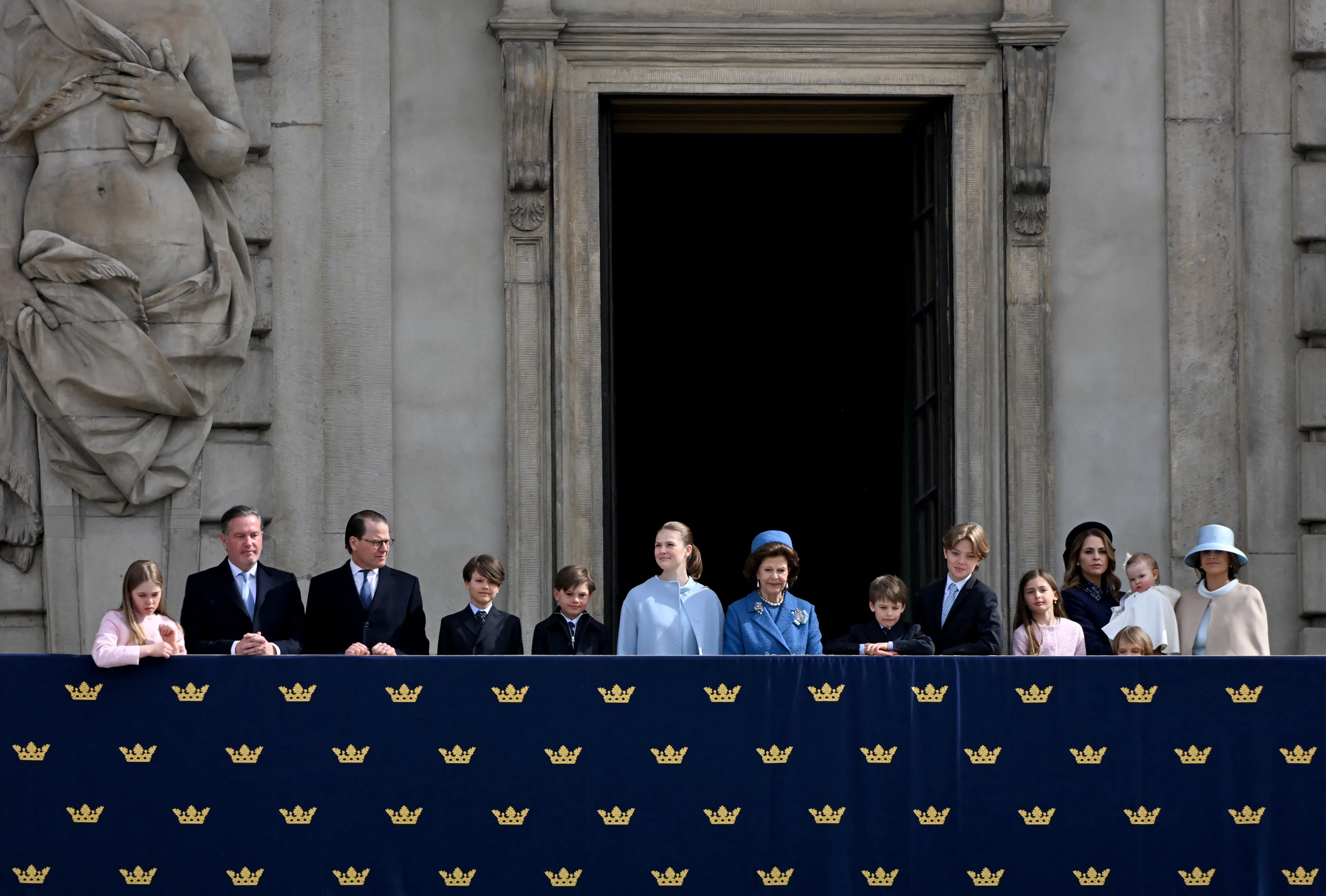De koninklijke familie kijkt toe vanaf het balkon.