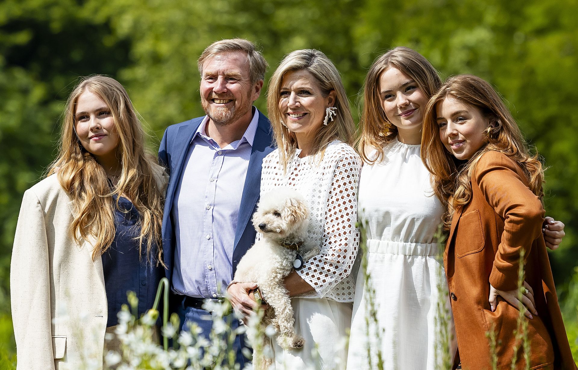 Koning Willem-Alexander en koningin Maxima samen met prinsessen Amalia, Alexia, Ariane en hondje Mambo.