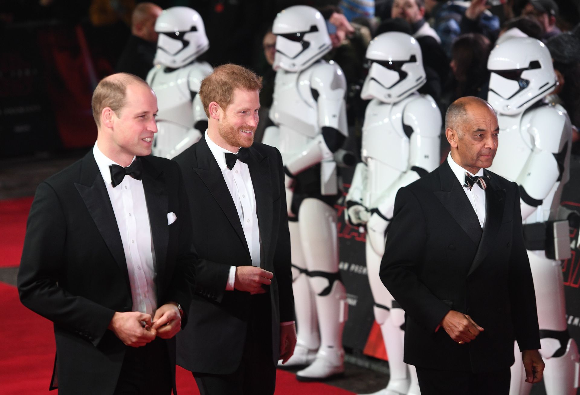 Prins William en prins Harry lopen langs een aantal stormtroopers.