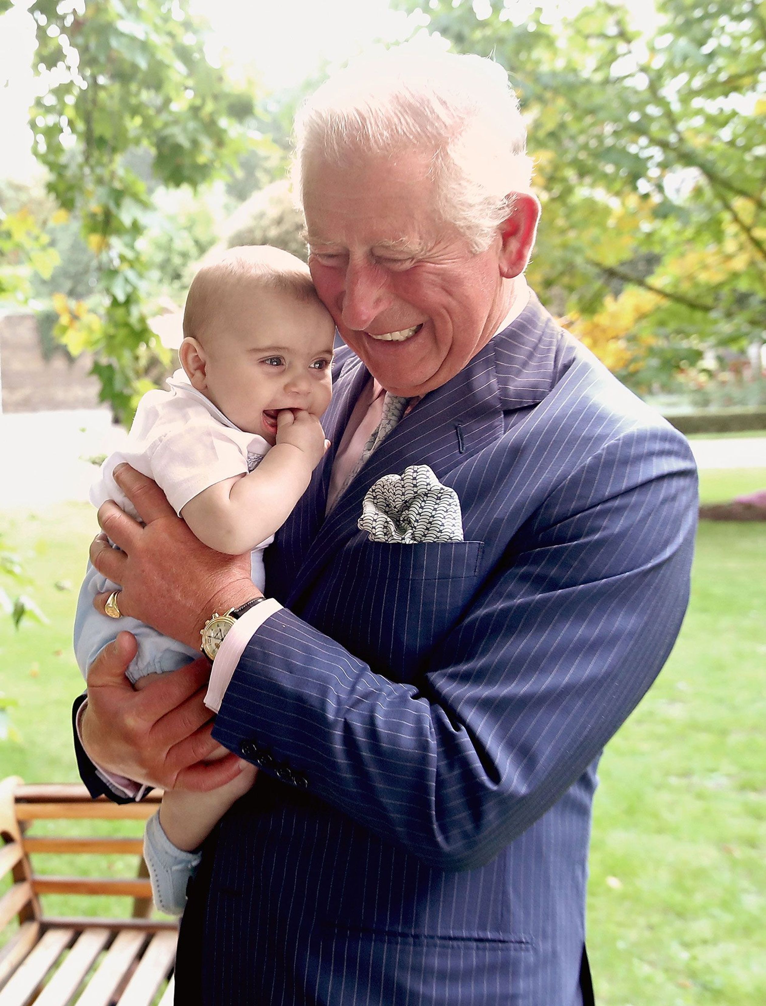 Charles twee keer in een liefdevolle omhelzing met baby Louis.